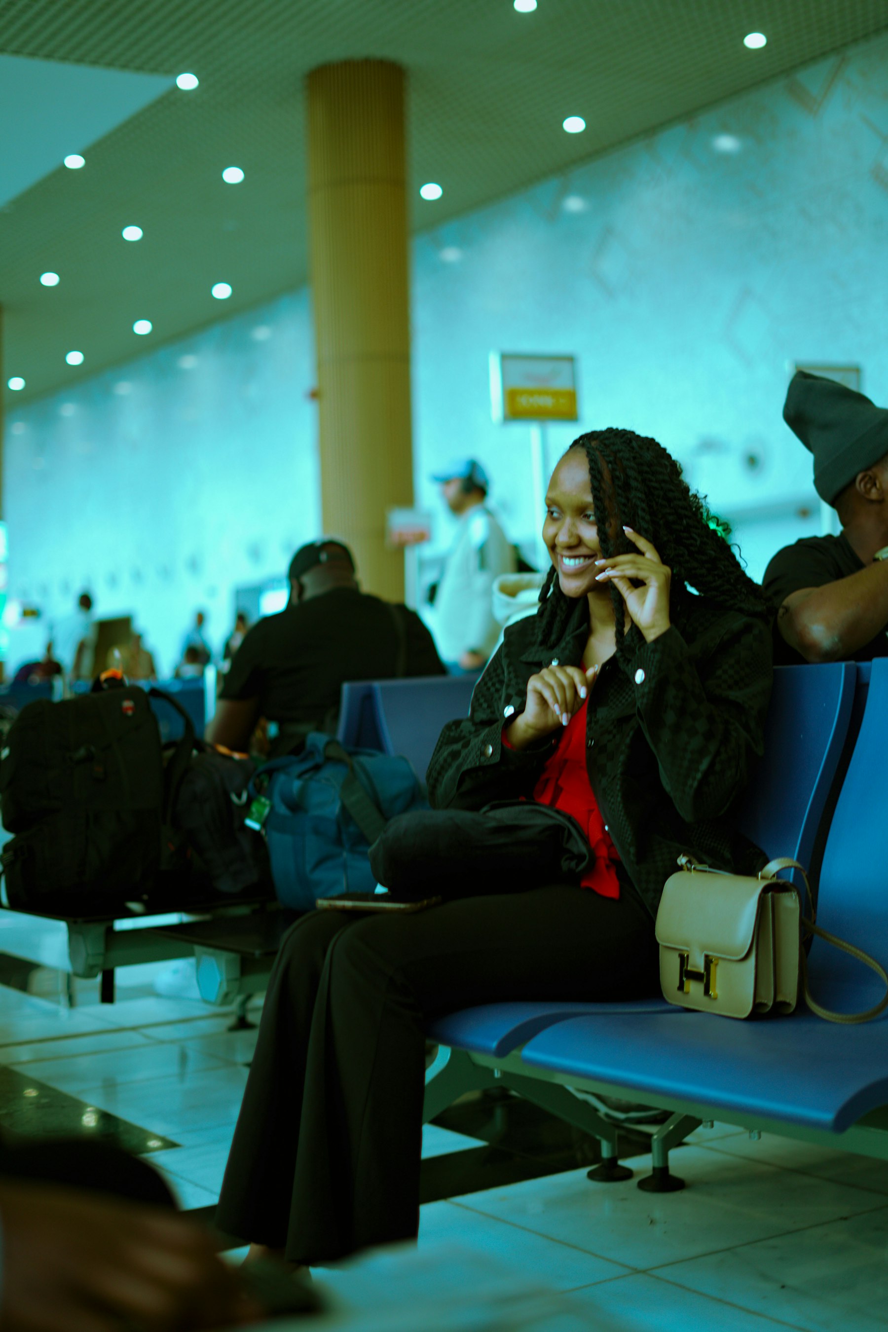 A smiling traveller waiting at an airport gate